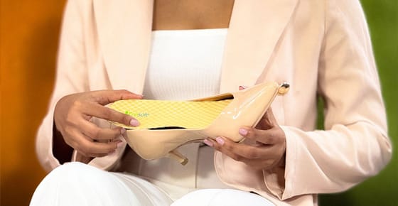 girl-inserting-insole-in-to-beige-shoe